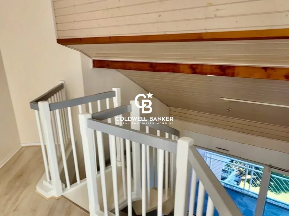 Spiral staircase leading to an upper floor in a duplex apartment.