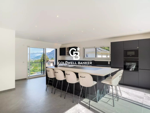 Modern interior of an open kitchen with bar and mountain view.