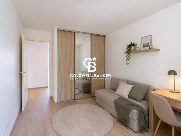 Bedroom in a new house with a sofa, a desk and a mirror, in Etaux.