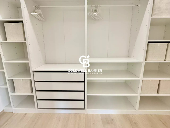 Interior of a modern dressing room with shelves and drawers, house for sale in Etaux.