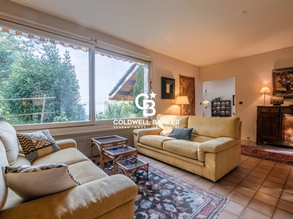 Salon lumineux d'une villa à Vétraz-Monthoux avec vue sur le jardin et la nature environnante.