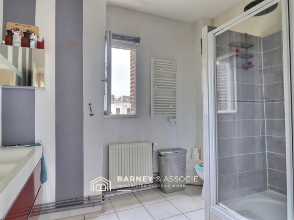 Salle de bain moderne avec douche et lavabo dans une maison ancienne à Bihorel.