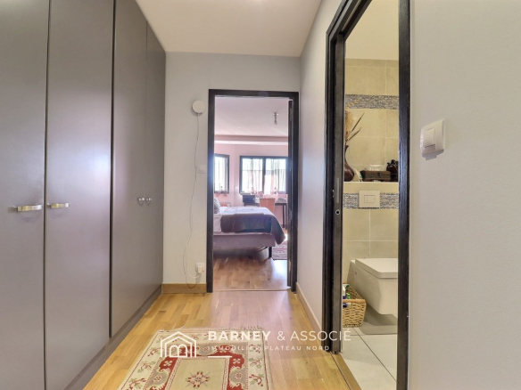 Interior of a contemporary house with a hallway leading to a bedroom and a bathroom.
