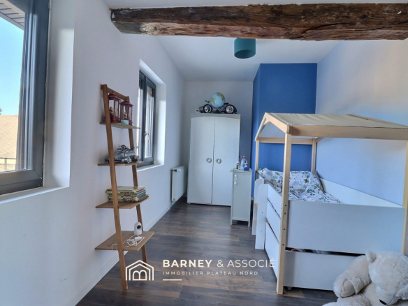 Chambre d'enfant dans une maison rénovée à Esclavelles, avec lit et rangement.