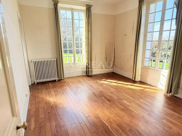 Interior of a house with wooden parquet flooring and large windows, La Chapelle-Gauthier.