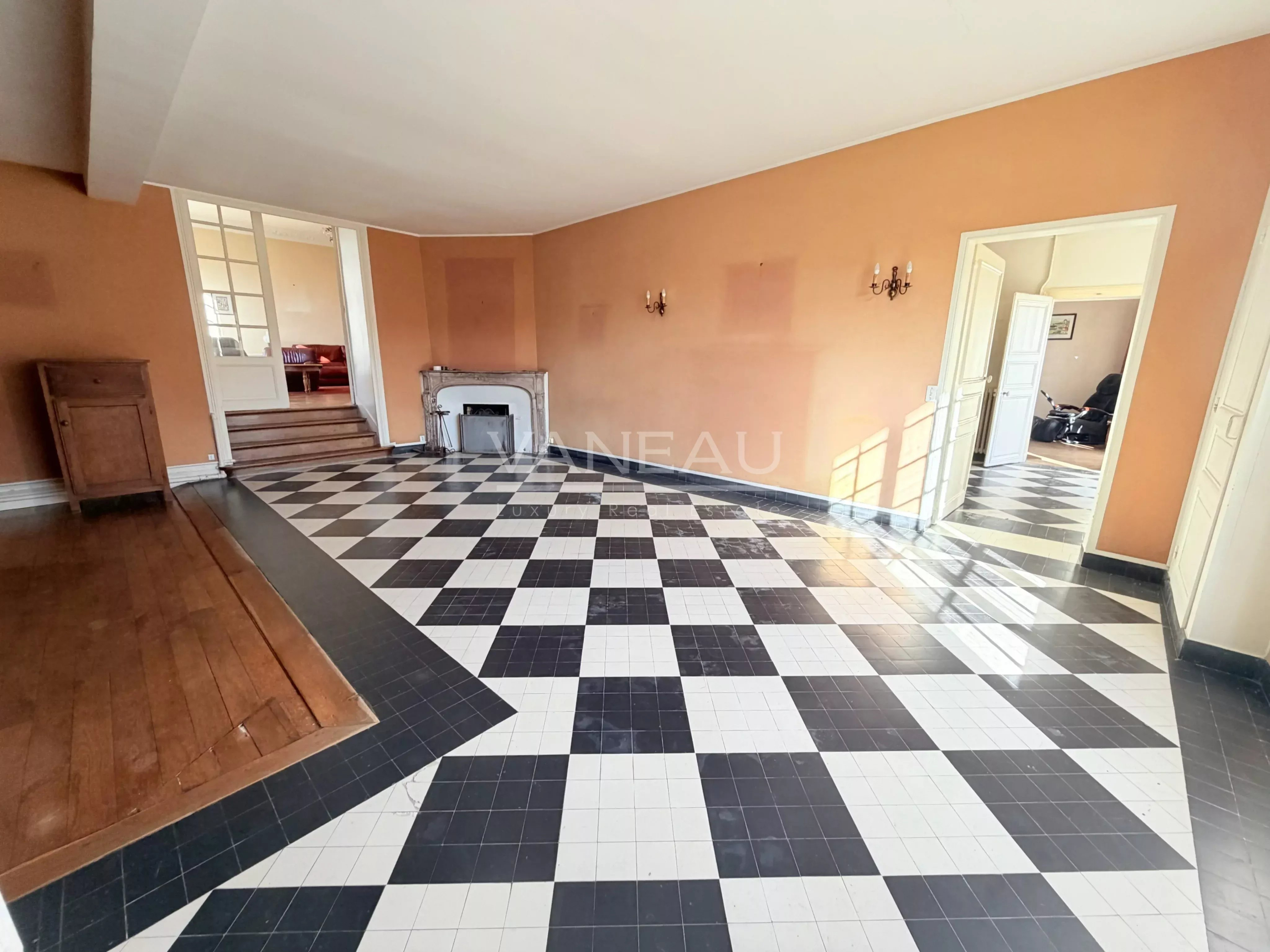 Interior of a farmhouse in La Chapelle-Gauthier Interior of a farmhouse with a black and white checkered floor, orange walls and a fireplace.