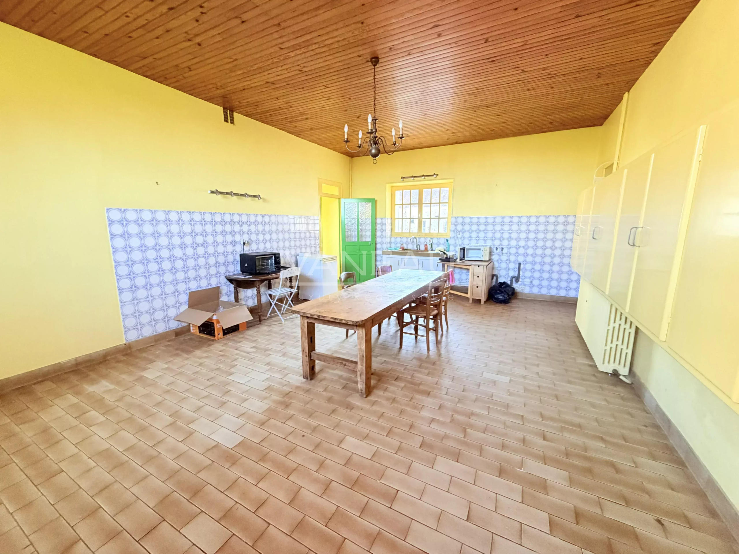 Farmhouse kitchen in La Chapelle-Gauthier Interior of a spacious kitchen with tiled floors and yellow walls in a farmhouse in La Chapelle-Gauthier.