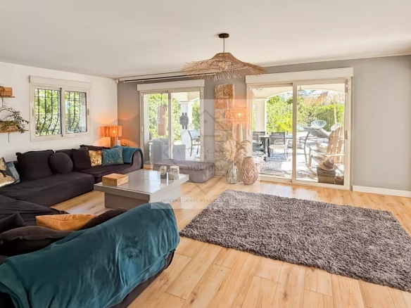 Interior of a modern house with a bright living room and access to a terrace.