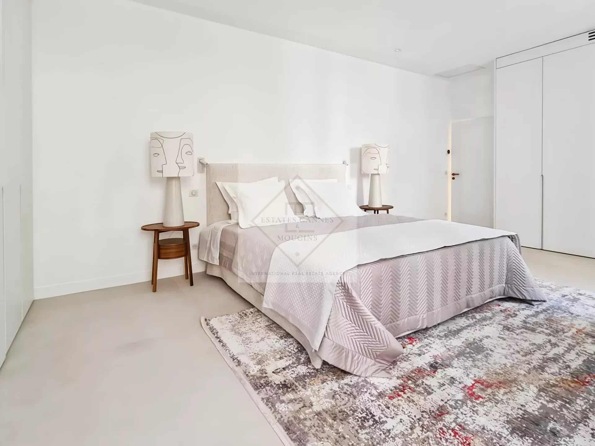 Chambre moderne avec lit double et décoration minimaliste dans une maison de ville à Cannes.