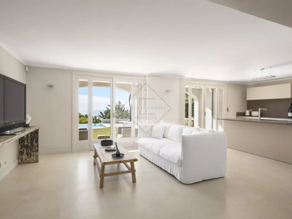 Interior of a spacious villa in Cannes with a bright living room and sea view.