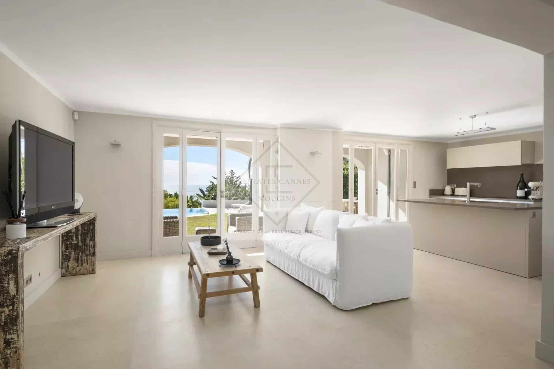 Interior of a spacious villa in Cannes with a bright living room and sea view.
