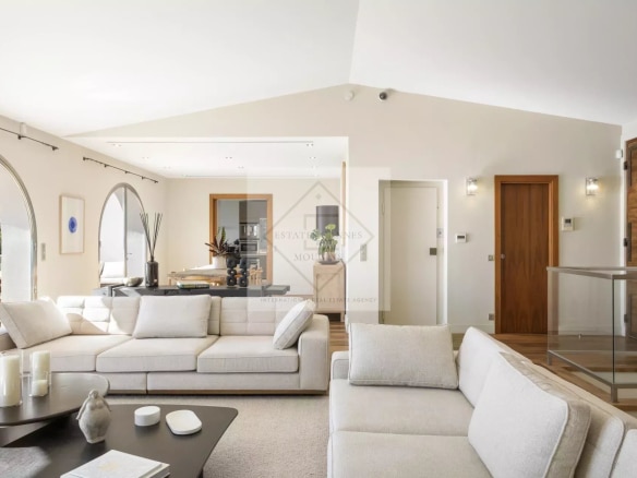 Bright interior of a spacious villa in Cannes, with a modern living room and views of the outside.