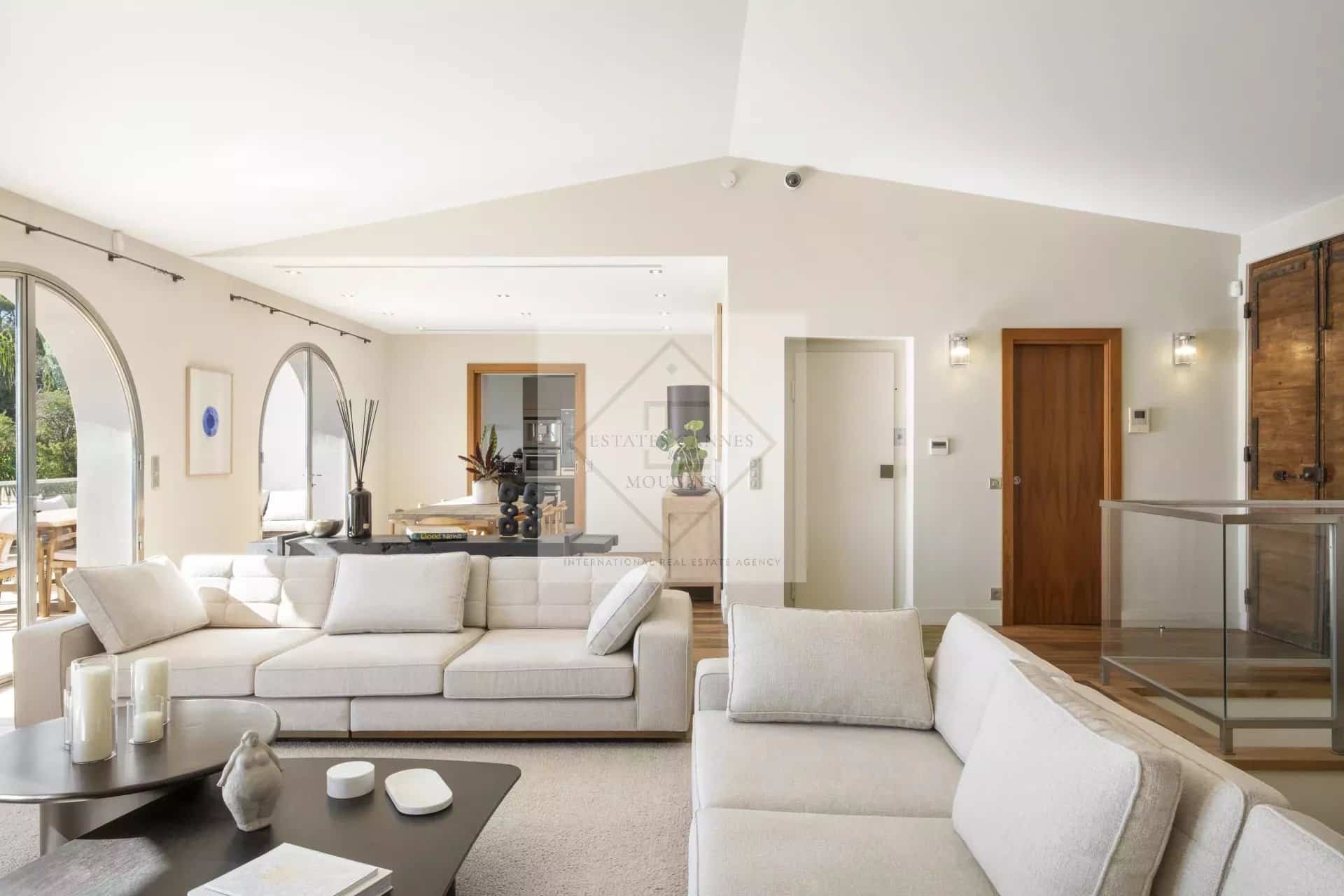 Bright interior of a spacious villa in Cannes, with a modern living room and views of the outside.