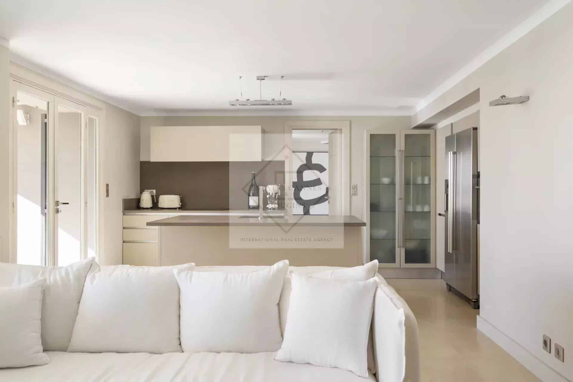 Interior of a spacious villa in Cannes with a modern kitchen and bright living room.