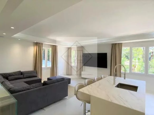 Modern interior of a villa in Mougins with living room and open kitchen.