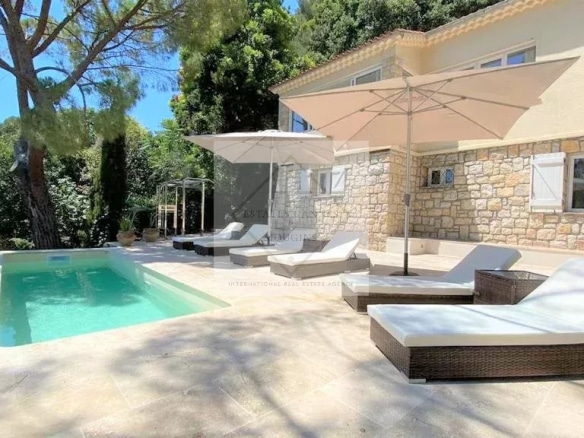 Terrace with swimming pool and sun loungers in a villa in Mougins, French Riviera.