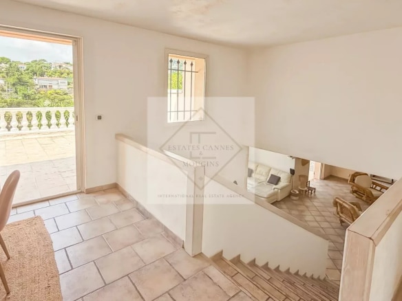 Interior of a villa in Antibes with a staircase and a view of nature.