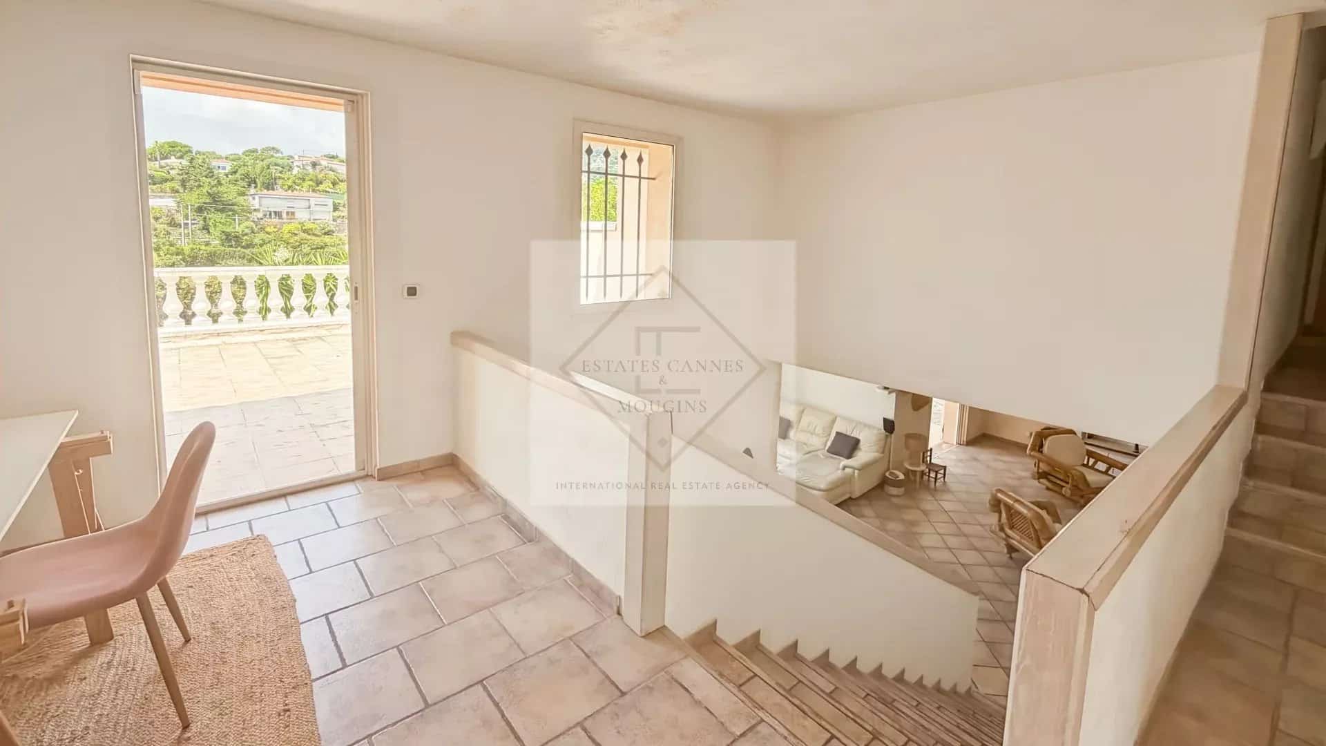 Interior of a villa in Antibes with a staircase and a view of nature.