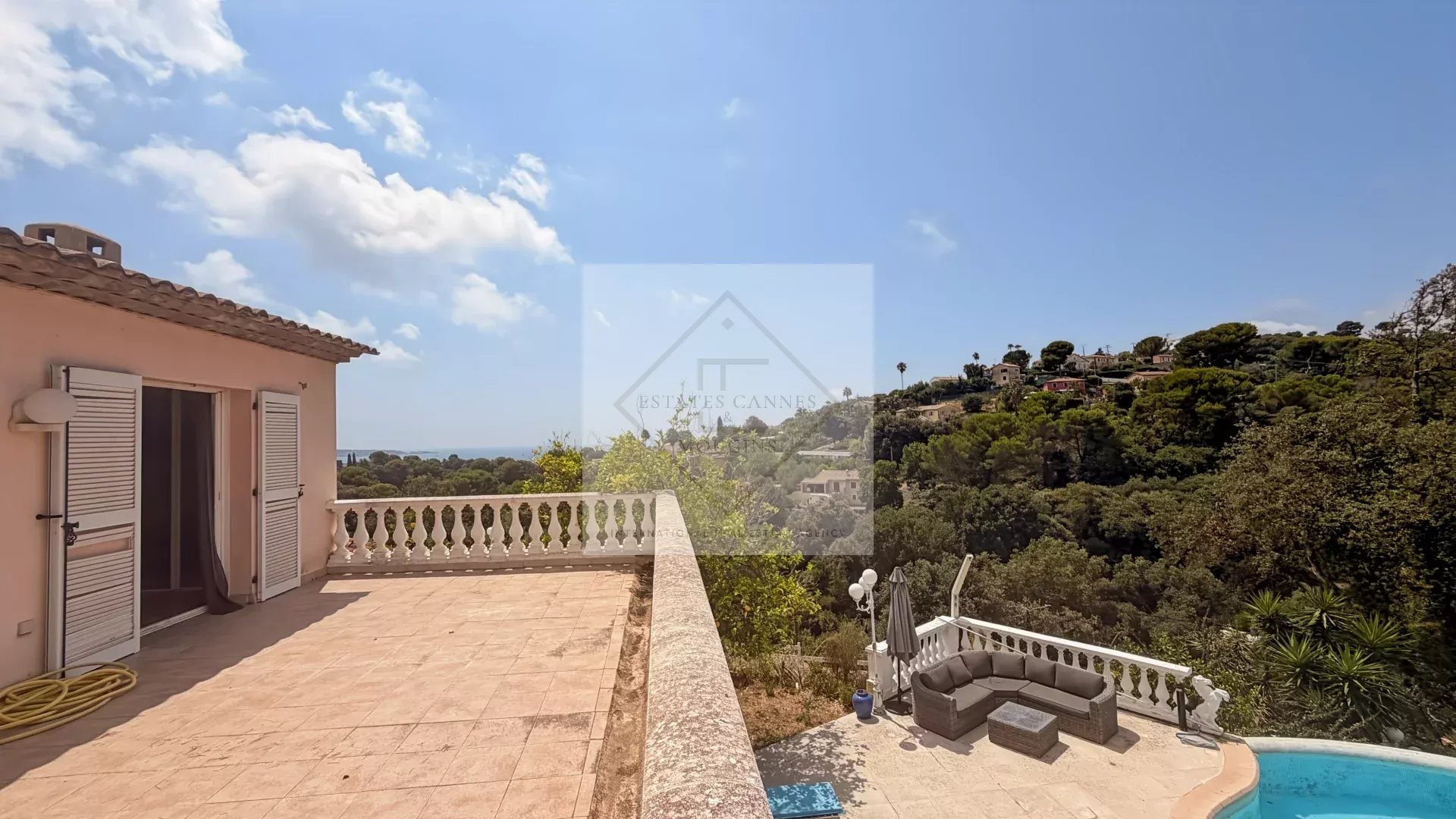 Unobstructed sea view from a villa in Antibes, with stone terrace and surrounding nature.