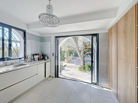 Modern interior of a luxury villa in Cannes with a kitchen opening onto the garden.