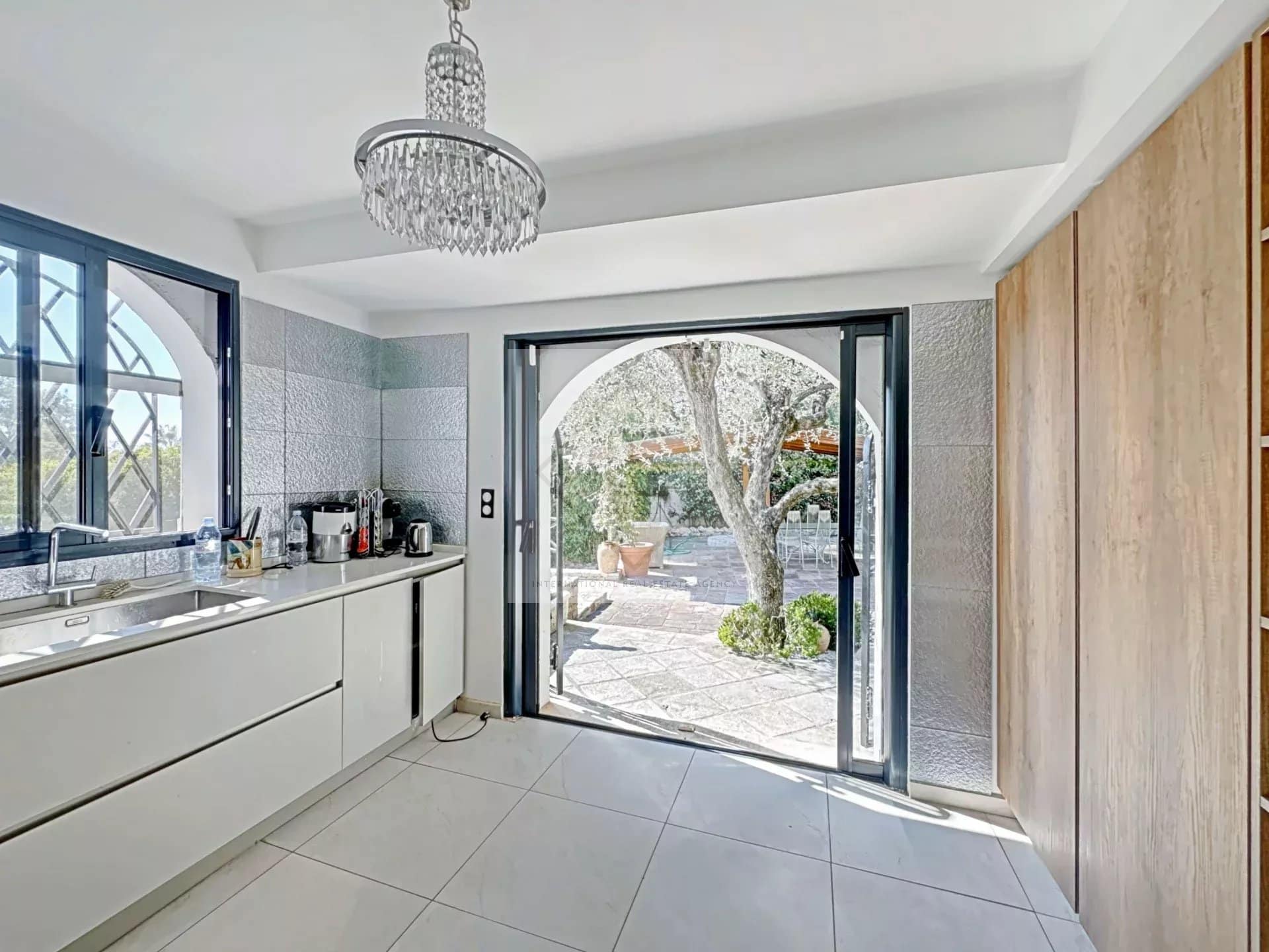 Modern interior of a luxury villa in Cannes with a kitchen opening onto the garden.