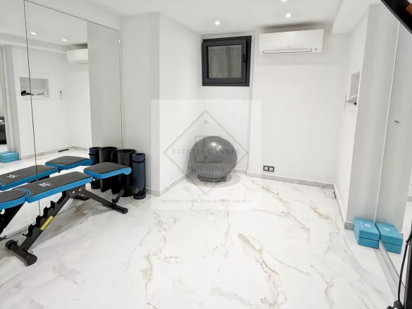 Interior of a luxury villa in Cannes with modern fitness equipment.