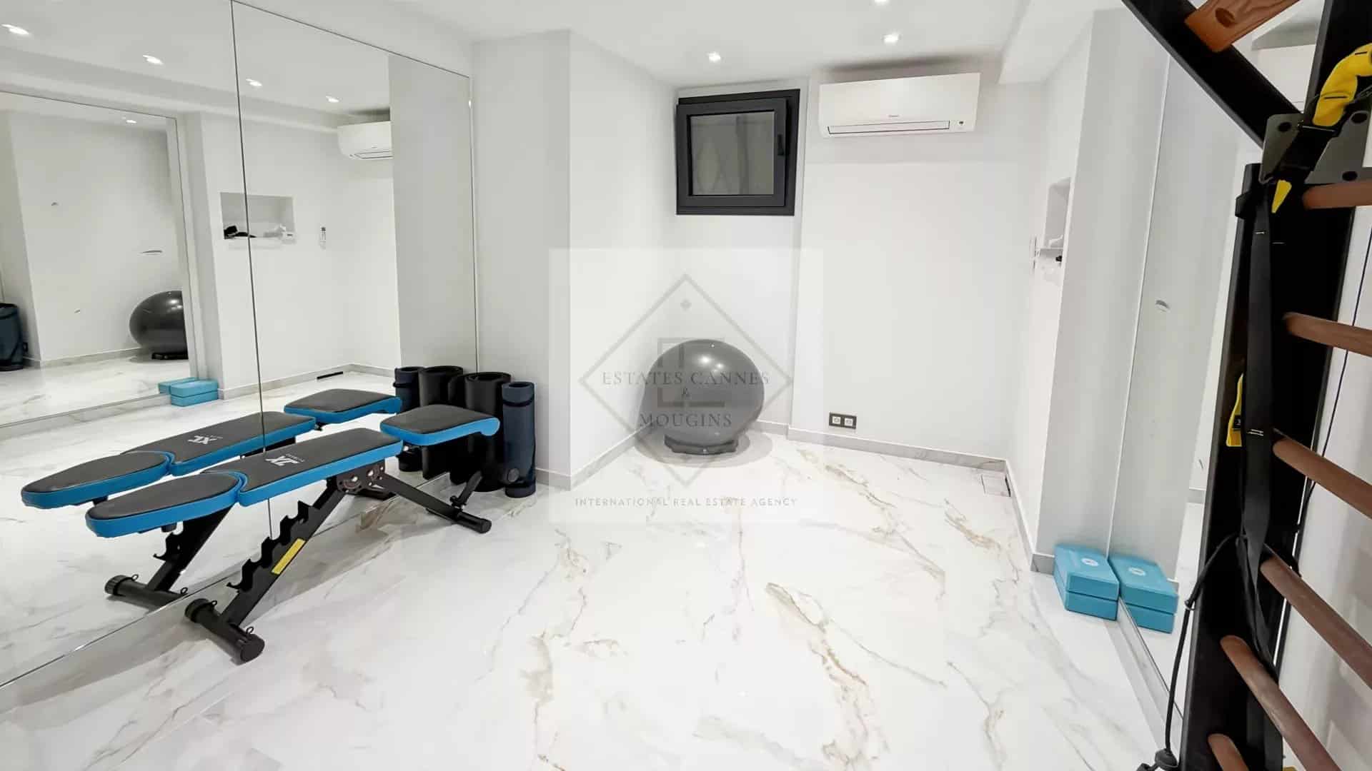 Interior of a luxury villa in Cannes with modern fitness equipment.