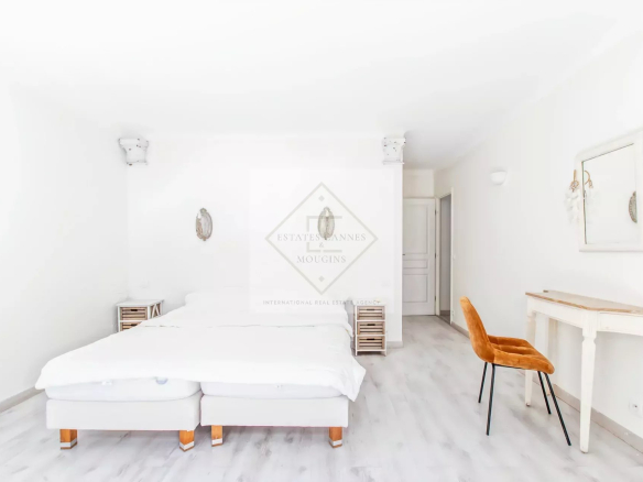 Chambre lumineuse avec lit double et mobilier moderne dans une villa à Mandelieu-la-Napoule.