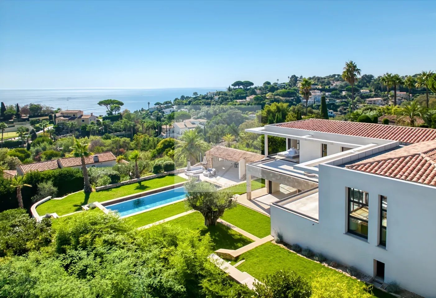 Contemporary villa in Super Cannes Aerial view of a contemporary villa with swimming pool and garden, overlooking the sea in Cannes.