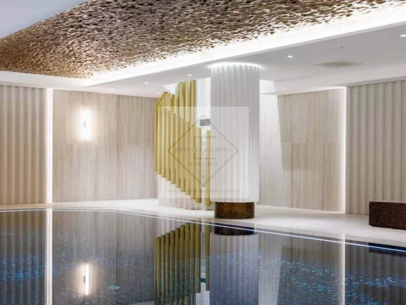 Interior of a historic residence in Cannes with swimming pool and elegant decor.