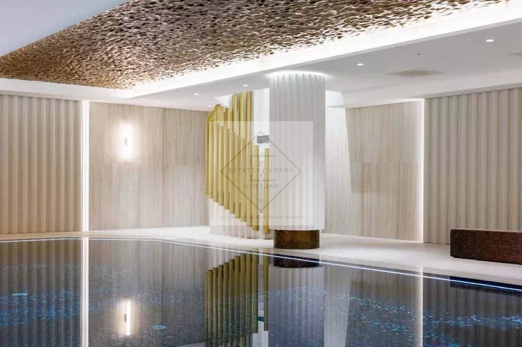 Interior of a historic residence in Cannes with swimming pool and elegant decor.