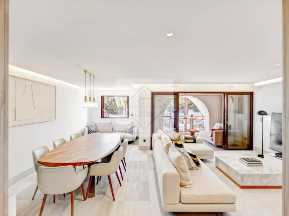 Interior of a modern apartment with dining room and lounge area, sea view.