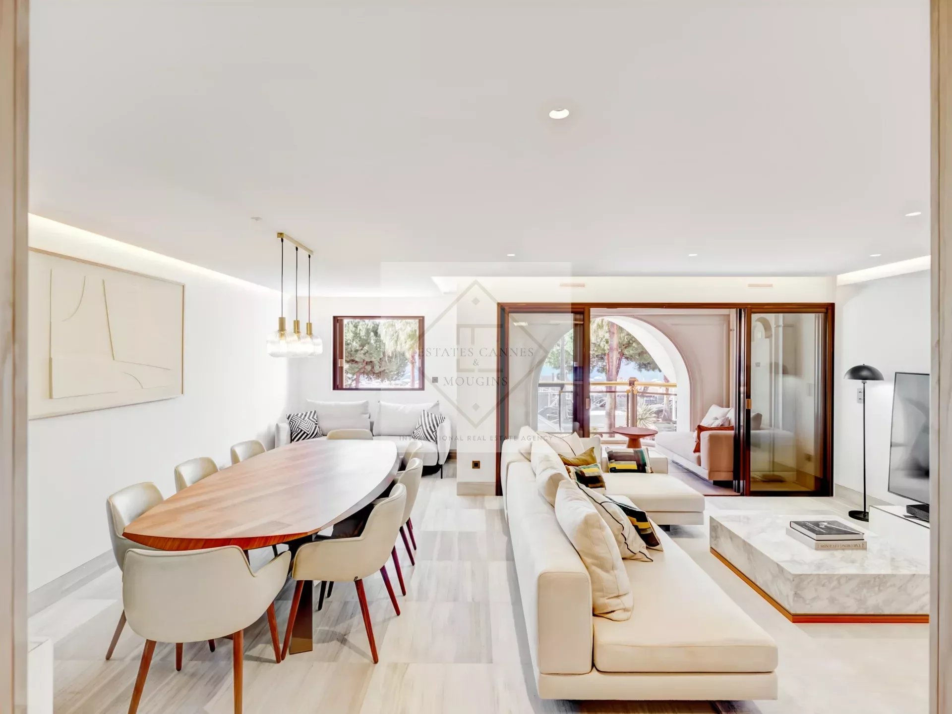 Interior of a modern apartment with dining room and lounge area, sea view.
