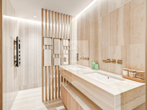 Modern bathroom with double sink and wooden elements.