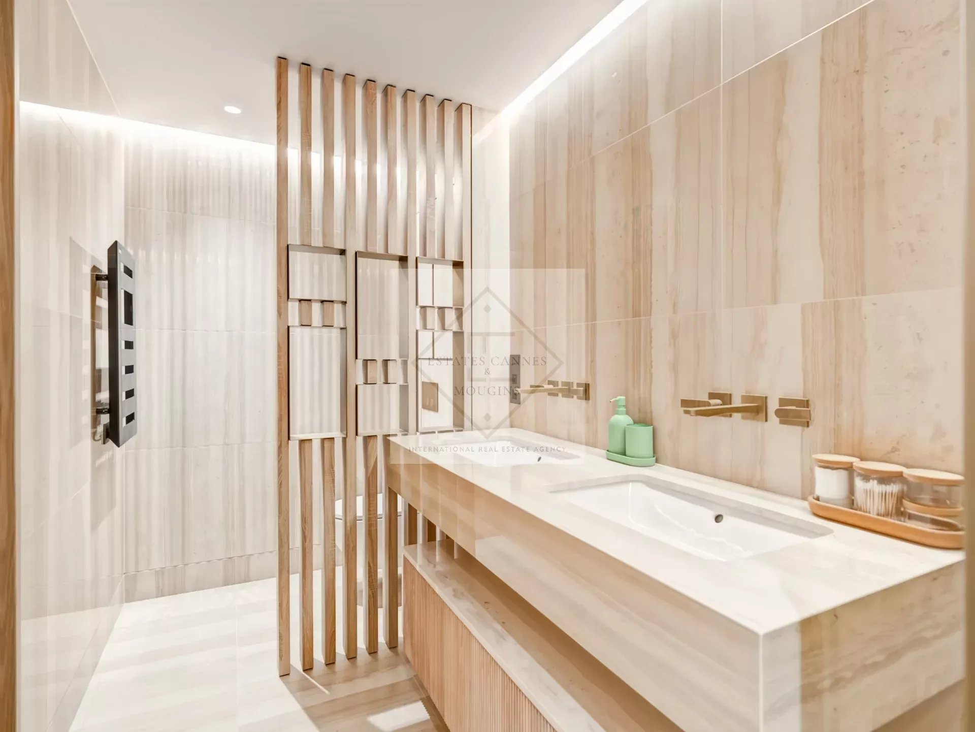 Modern bathroom with double sink and wooden elements.