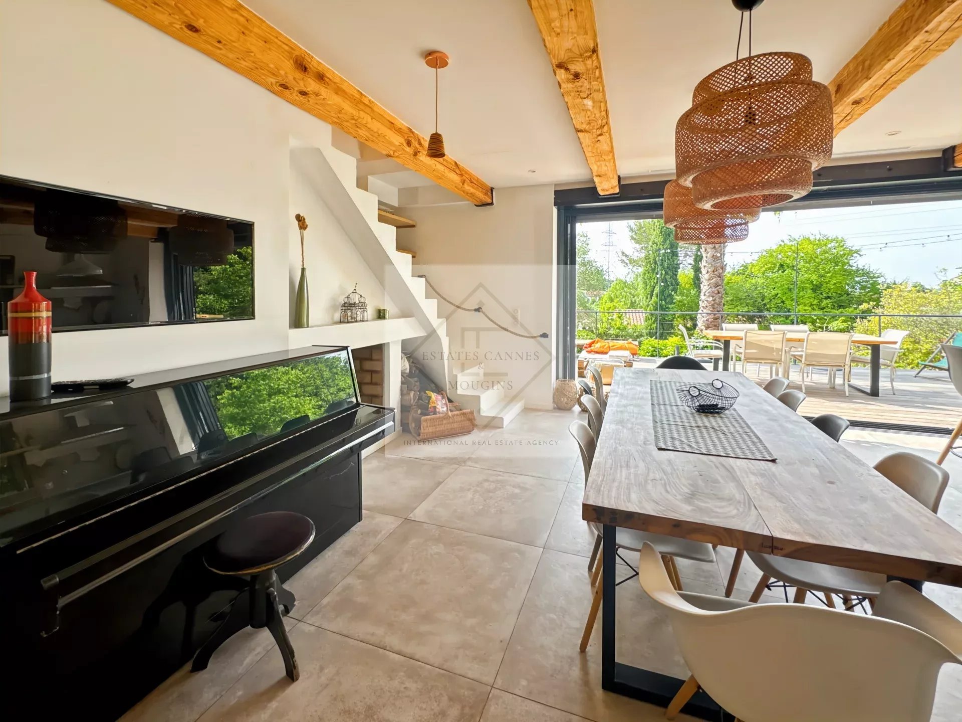 Interior of a house in Mougins Interior of an elegant house with a living room, a dining room and a view of the garden.