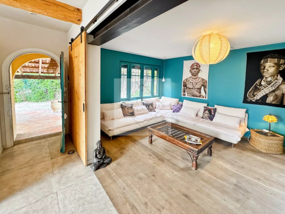 Interior of an elegant house with a bright living room and artwork on the wall.