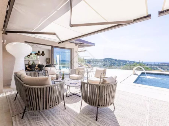 Terrace of a modern villa with sea view, contemporary furniture and swimming pool in Mougins.