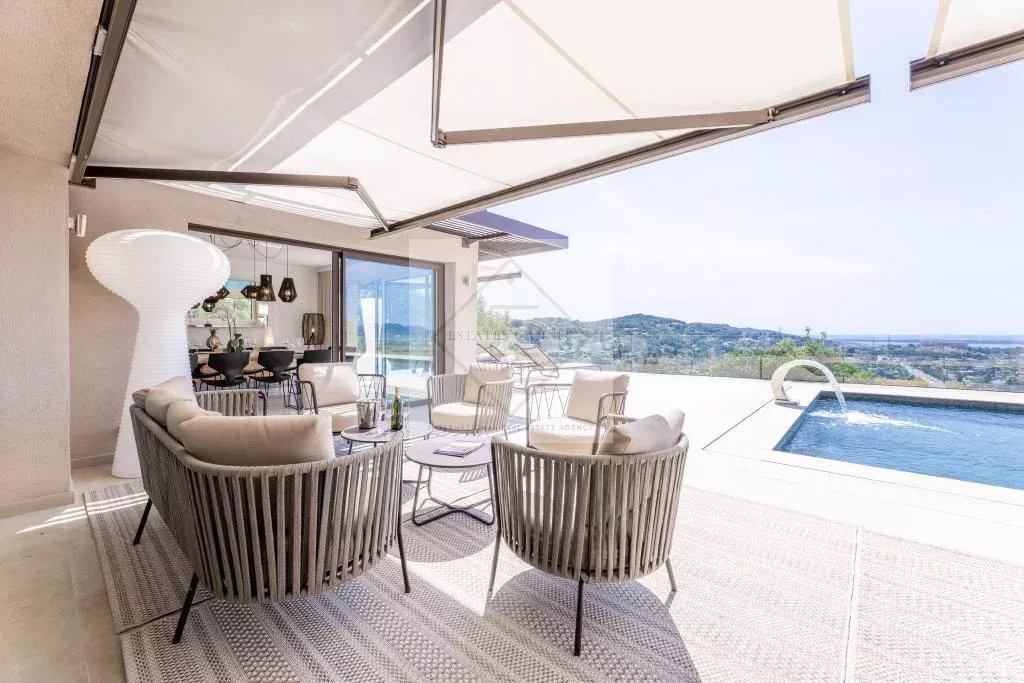 Modern villa with sea view in Mougins Terrace of a modern villa with sea view, contemporary furniture and swimming pool in Mougins.