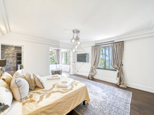 Chambre spacieuse et lumineuse d'une villa à Saint-Paul-de-Vence, avec lit et décoration élégante.