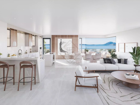 Interior of a modern penthouse with sea views, bright living room and open kitchen.