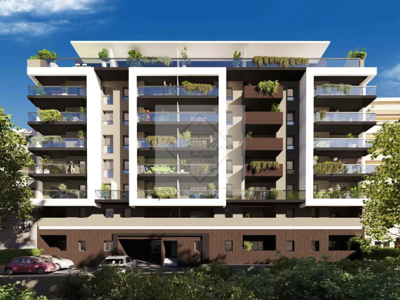 Facade of a modern building in Antibes with balconies and vegetation.