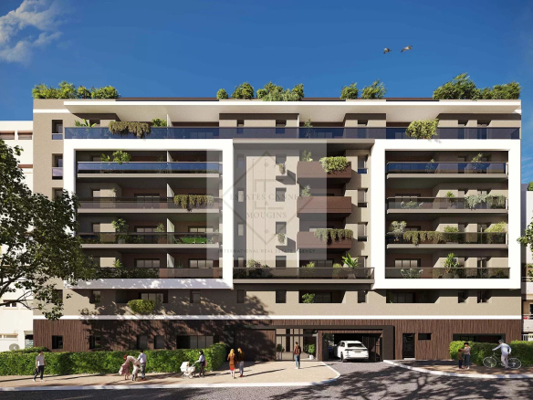 Facade of a modern building with balconies and green spaces in Antibes.