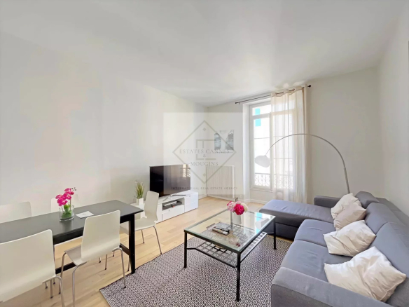 Bright living room of an apartment in Cannes with dining table and sofa