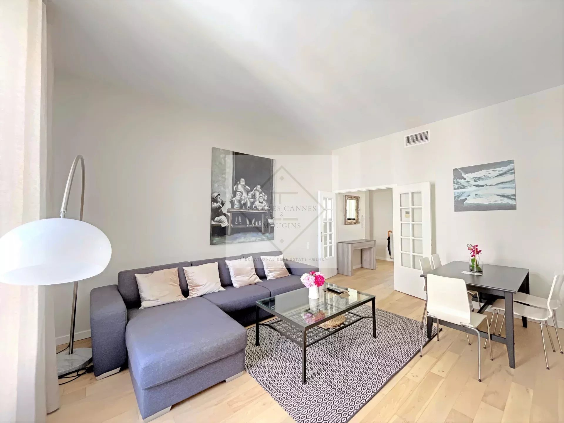 Living room of an apartment in Cannes Bright living room of an apartment in Cannes with sofa and dining table.