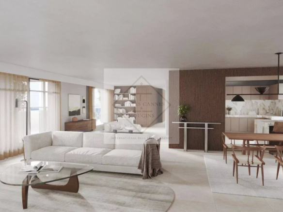 Intérieur d'un appartement neuf à Juan-les-Pins avec salon moderne et cuisine ouverte.