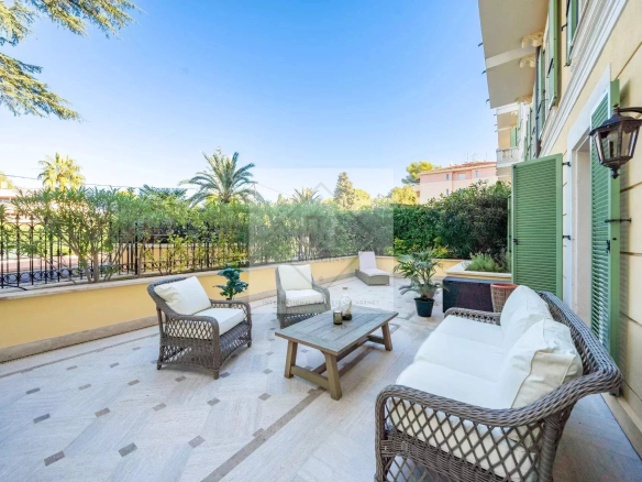Terrace of an apartment in Cannes with wicker furniture and plants