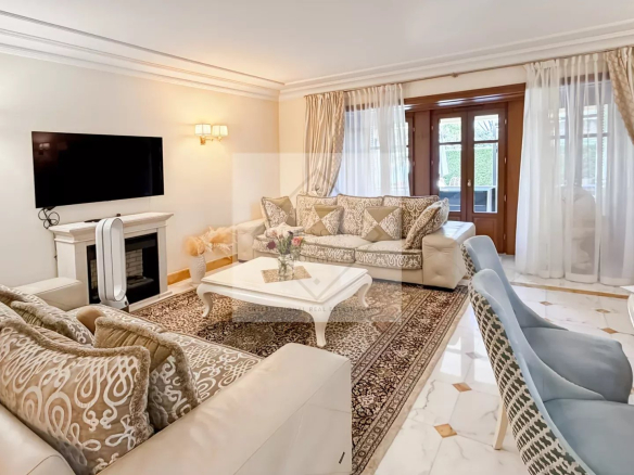 Living room of a luxury apartment in Cannes with elegant furniture and fireplace.