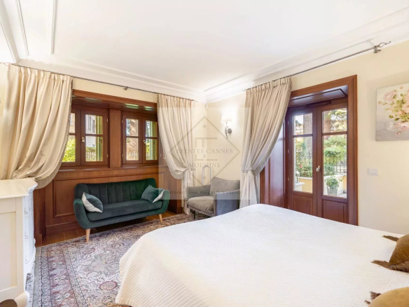 Room in an elegant apartment with wooden windows and classic decor in Cannes.