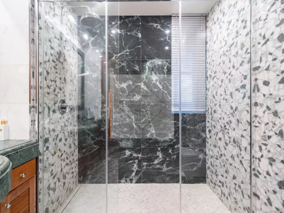 Modern bathroom with glass shower and marble tiles